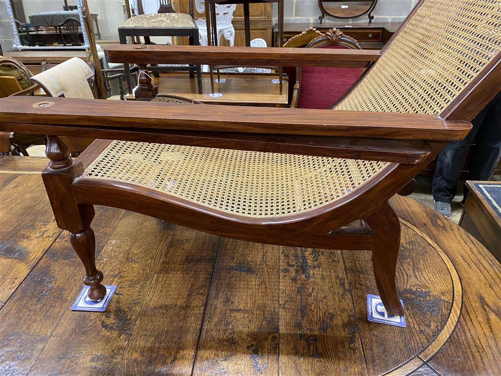 A caned hardwood plantation chair, width 70cm, depth 110cm, height 89cm